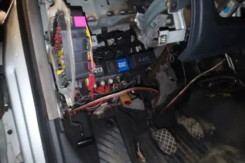 Audi A4 B6 bezpieczniki pod maską. Widoczne przewody i skrzynka z bezpiecznikami, przygotowanie do naprawy.