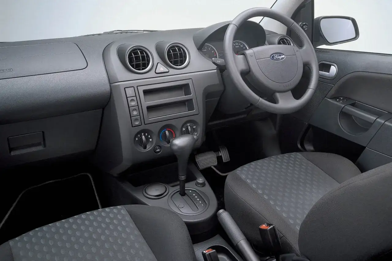 Wnętrze Ford Fiesta MK5: deska rozdzielcza, kierownica, fotele i automatyczna skrzynia biegów.